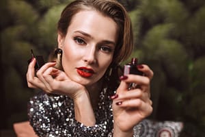 Young beautiful woman with wavy hairstyle and red lips in sequin picture
